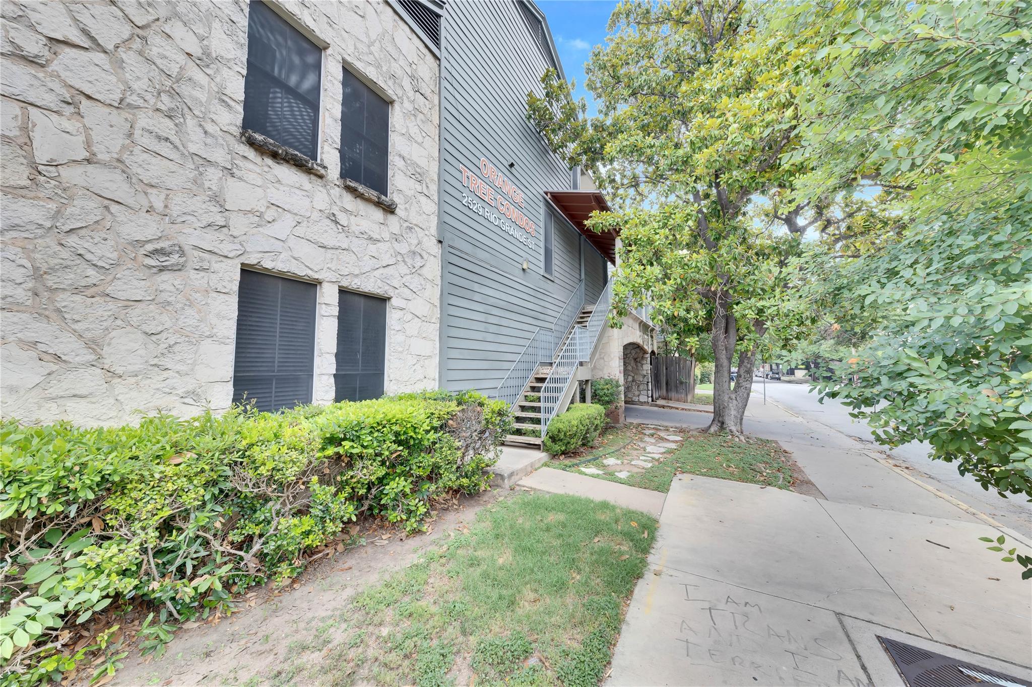 2529 Rio Grande Street, Unit 100 Austin, TX 78705 - Photo 4 of 14 a front view of a house with garden