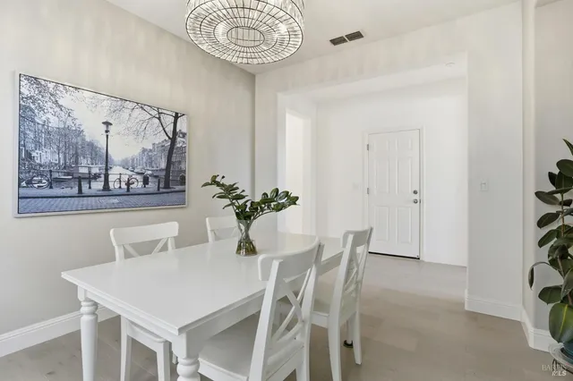 a view of a dining room with furniture and chandelier