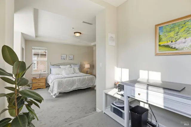 a bedroom with furniture and a lamp