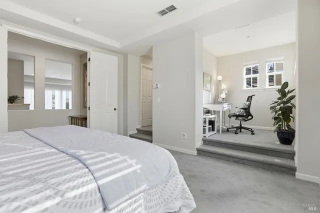 a bedroom with a bed and a mirror