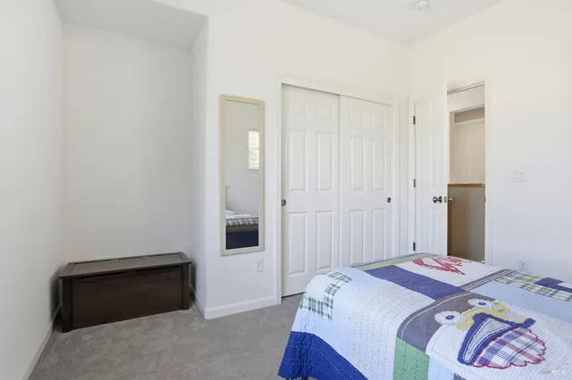 a bedroom with a bed and a cabinet