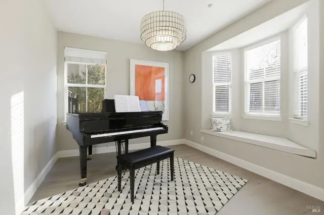 a dining room with wooden floor and a window