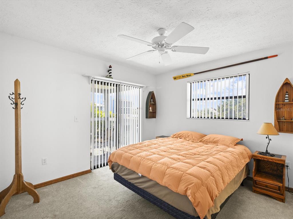 4290 Carlos Court Hernando Beach, FL 34607 - Photo 11 of 96 a bedroom with a large bed and a window