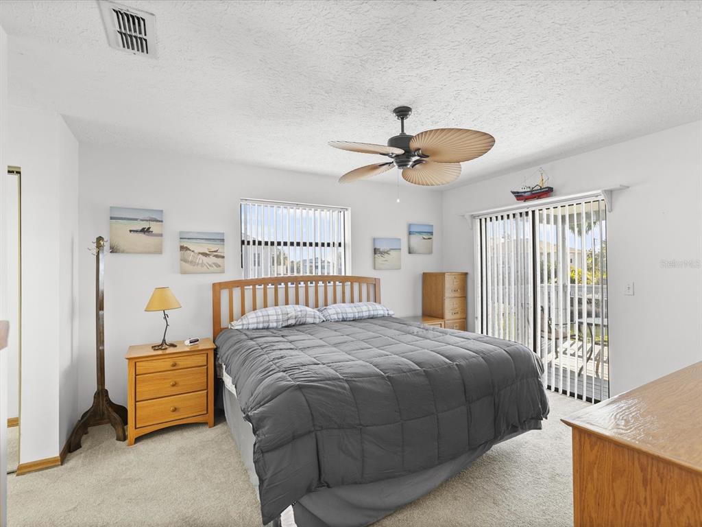 4290 Carlos Court Hernando Beach, FL 34607 - Photo 12 of 96 a bedroom with a bed and a chandelier