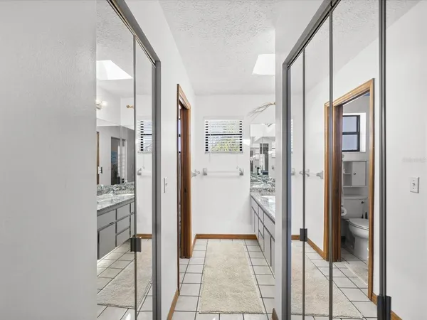 a living room with furniture a flat screen tv and a floor to ceiling window