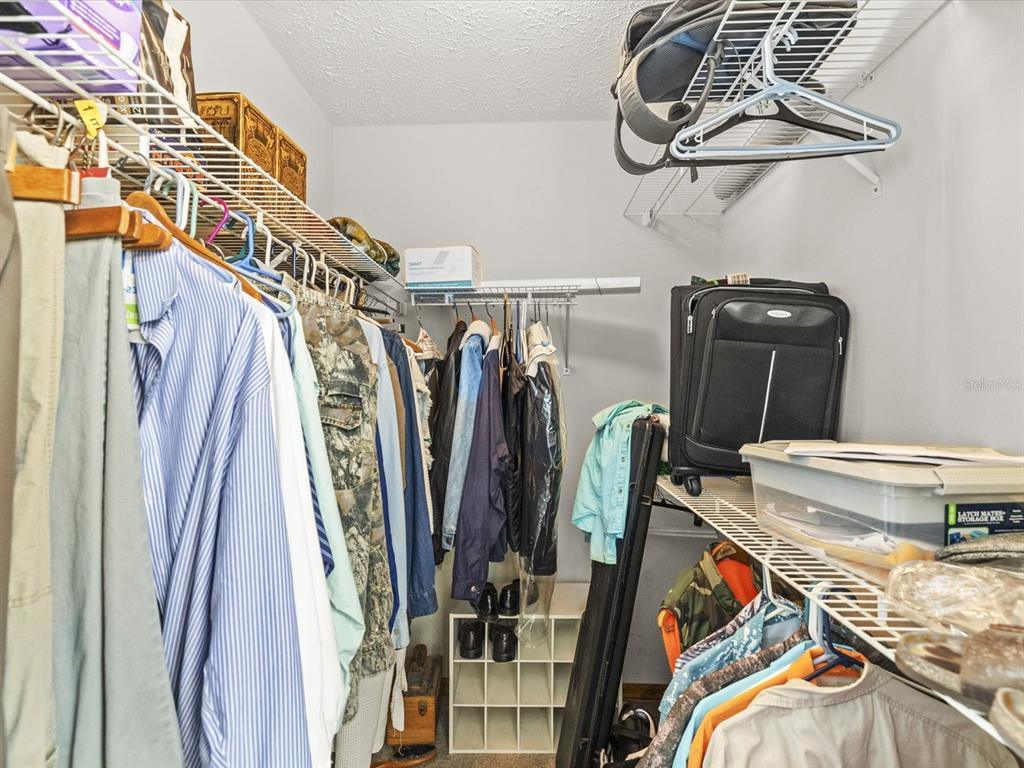 4290 Carlos Court Hernando Beach, FL 34607 - Photo 18 of 96 a view of walk in closet with clothes and shoes