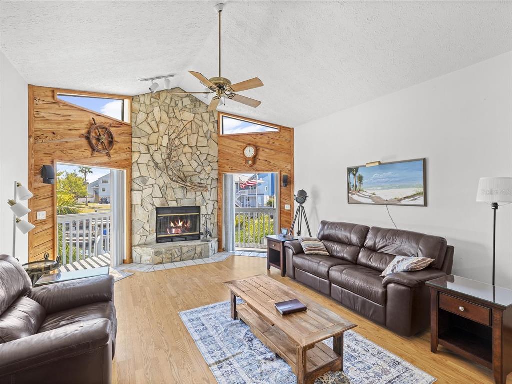 4290 Carlos Court Hernando Beach, FL 34607 - Photo 20 of 96 a living room with furniture a fireplace and a chandelier