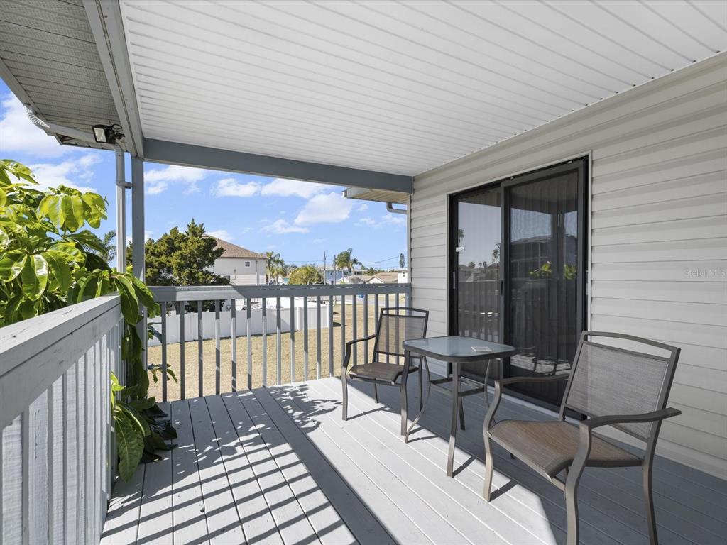 4290 Carlos Court Hernando Beach, FL 34607 - Photo 33 of 96 a view of a balcony with chairs and wooden floor