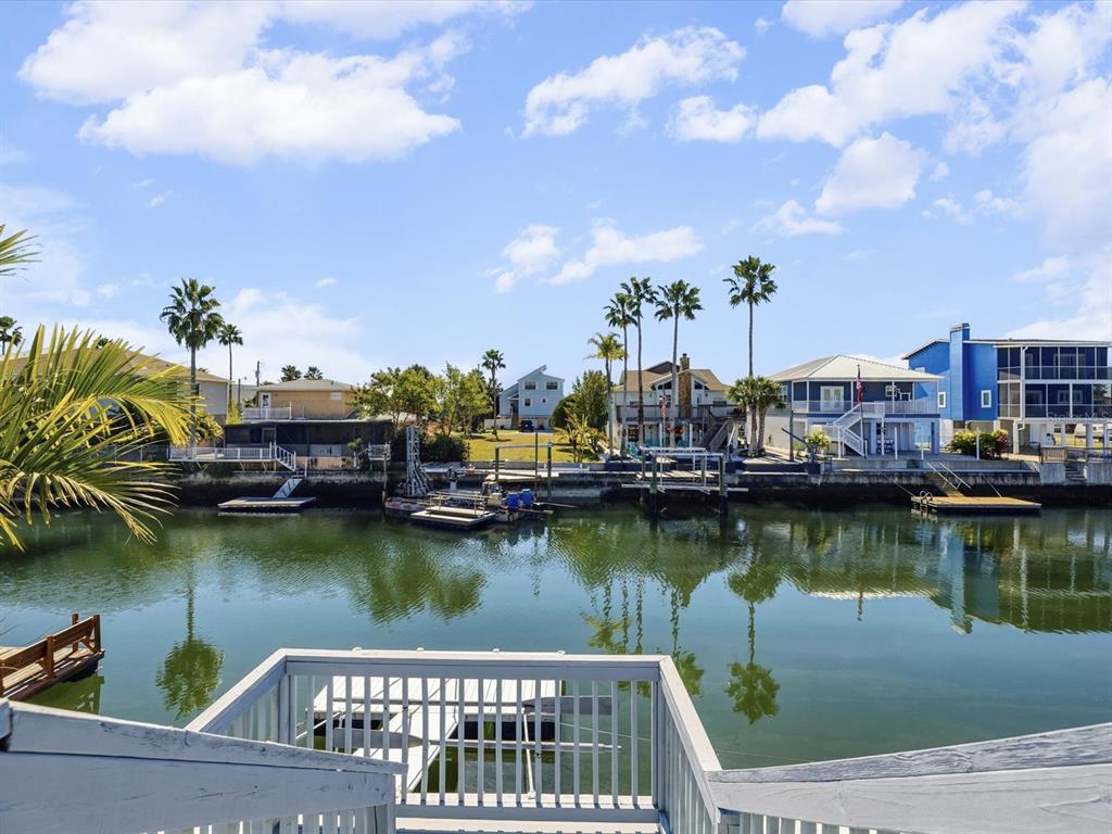 4290 Carlos Court Hernando Beach, FL 34607 - Photo 37 of 96 a view of a lake with a house in the background