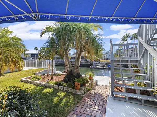 a view of a house with a yard and tree