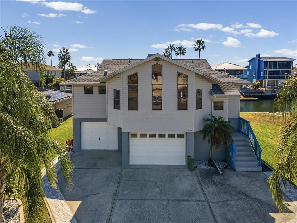 4290 Carlos Court Hernando Beach, FL 34607 - Photo 49 of 96 a front view of a house with a garden and plants