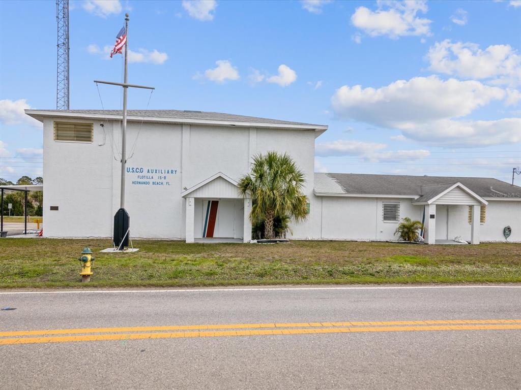 4290 Carlos Court Hernando Beach, FL 34607 - Photo 70 of 96 a front view of a house with a yard and garage