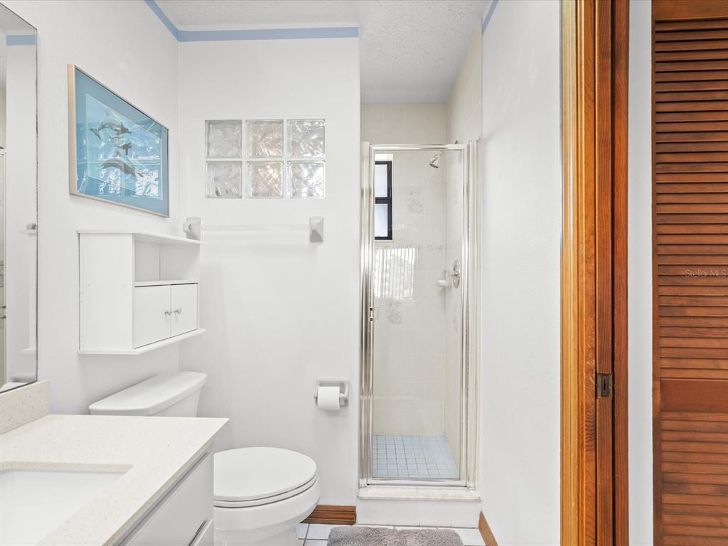 4290 Carlos Court Hernando Beach, FL 34607 - Photo 8 of 96 a bathroom with a toilet a sink and a shower