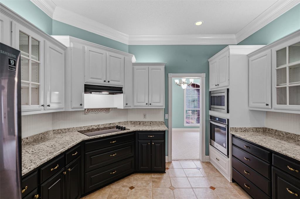 1304 Greenbriar Trail Holly Lake Ranch, TX 75765 - Photo 13 of 40 a kitchen with stainless steel appliances granite countertop a stove and a refrigerator