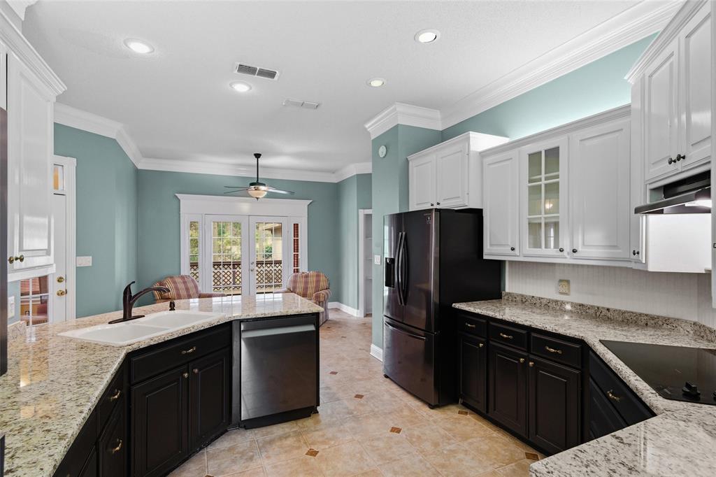 1304 Greenbriar Trail Holly Lake Ranch, TX 75765 - Photo 14 of 40 a kitchen with a refrigerator sink and stove