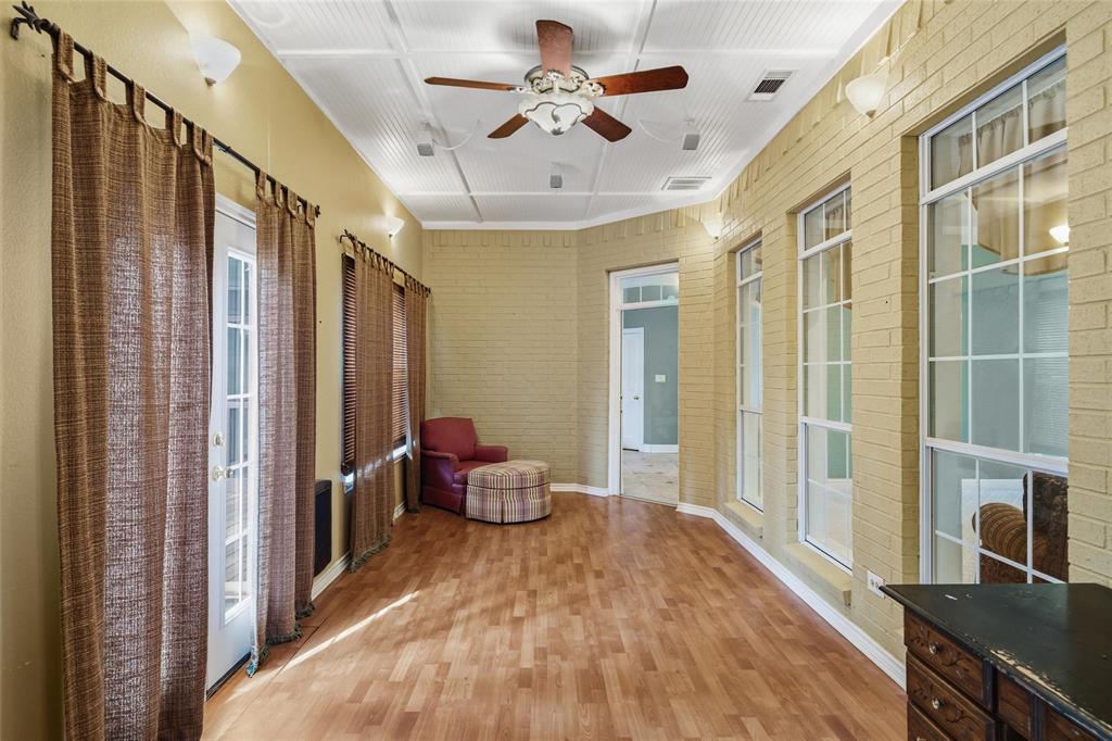 1304 Greenbriar Trail Holly Lake Ranch, TX 75765 - Photo 18 of 40 a view of a hallway with furniture and a chandelier fan