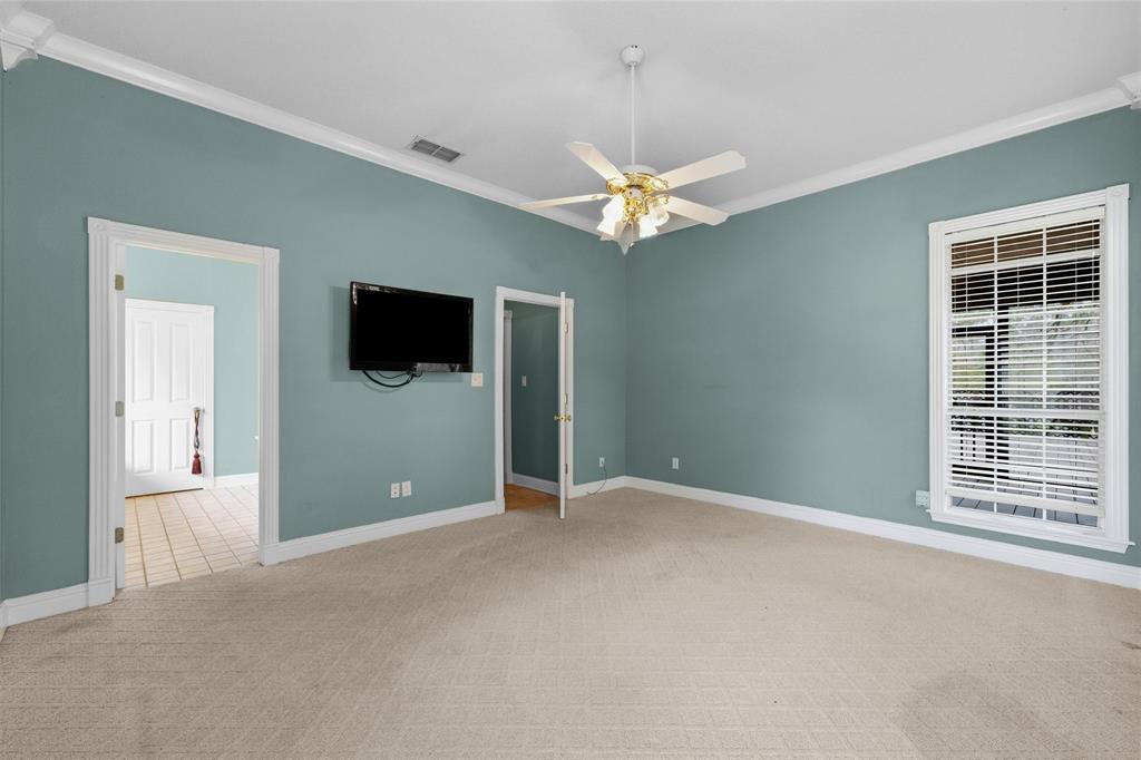 1304 Greenbriar Trail Holly Lake Ranch, TX 75765 - Photo 20 of 40 an empty room with windows and fan
