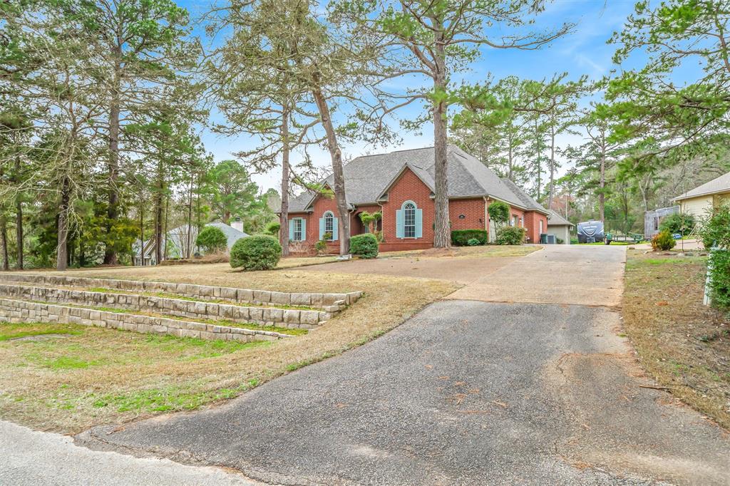 1304 Greenbriar Trail Holly Lake Ranch, TX 75765 - Photo 2 of 40 a view of house with a tree in front of it