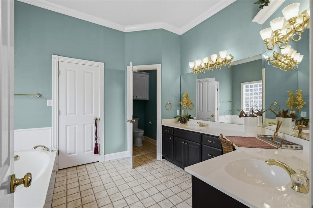 1304 Greenbriar Trail Holly Lake Ranch, TX 75765 - Photo 22 of 40 a spacious bathroom with a sink double vanity and a mirror