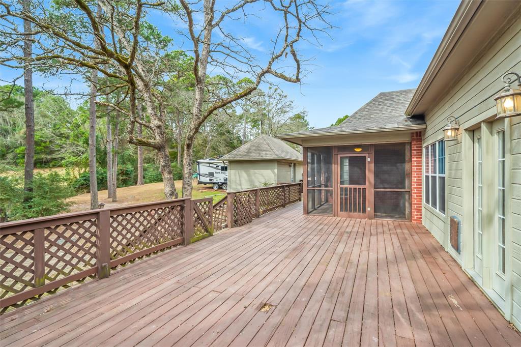1304 Greenbriar Trail Holly Lake Ranch, TX 75765 - Photo 31 of 40 a view of house with wooden deck and a large window