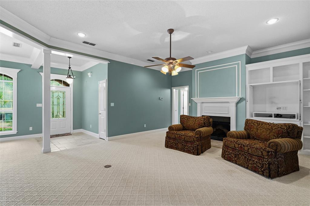 1304 Greenbriar Trail Holly Lake Ranch, TX 75765 - Photo 9 of 40 a living room with furniture and a chandelier