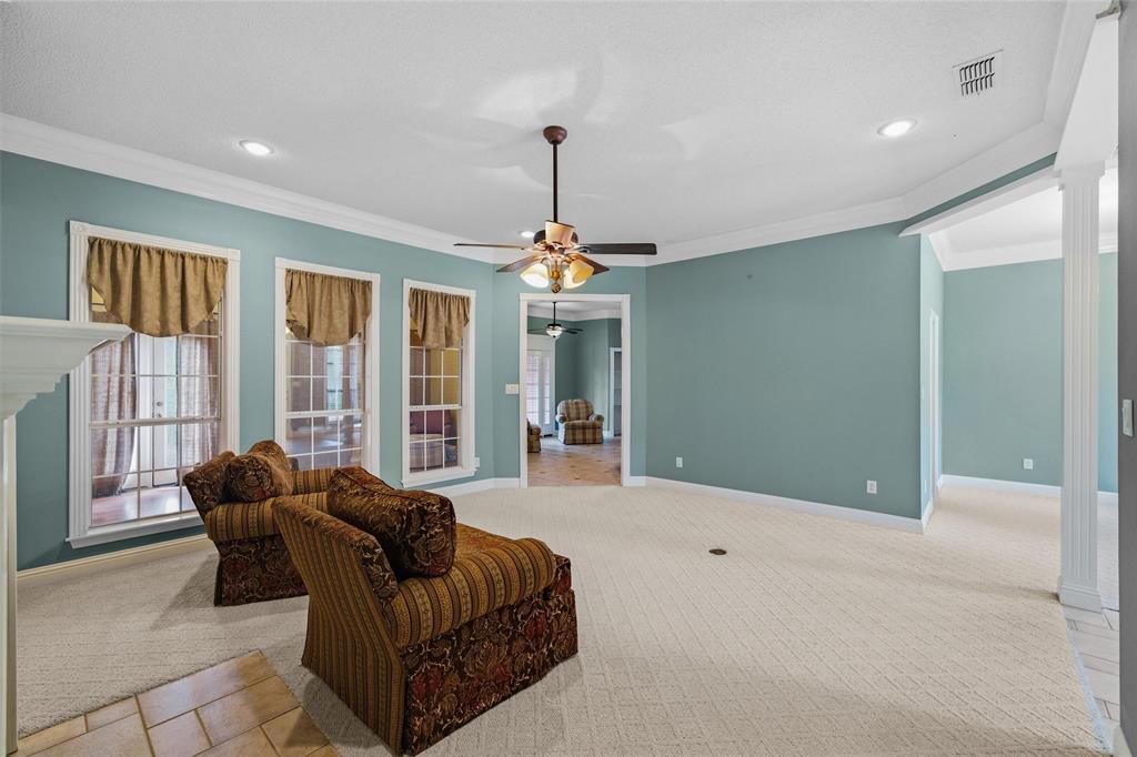 1304 Greenbriar Trail Holly Lake Ranch, TX 75765 - Photo 10 of 40 a living room with furniture and a chandelier