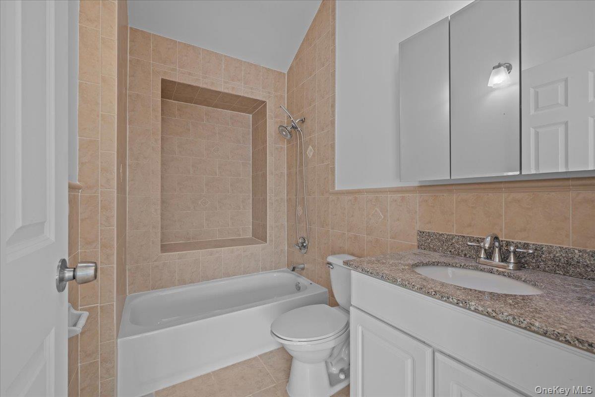 126 Beach 92nd Street, Unit 3C Queens, NY 11693 - Photo 11 of 16 a bathroom with a granite countertop sink toilet and shower