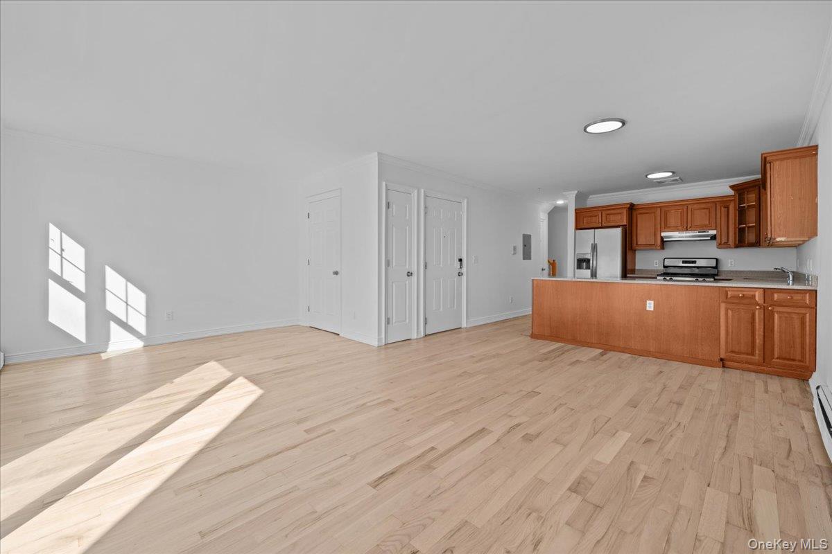 126 Beach 92nd Street, Unit 3C Queens, NY 11693 - Photo 15 of 16 a large room with a bed and furniture