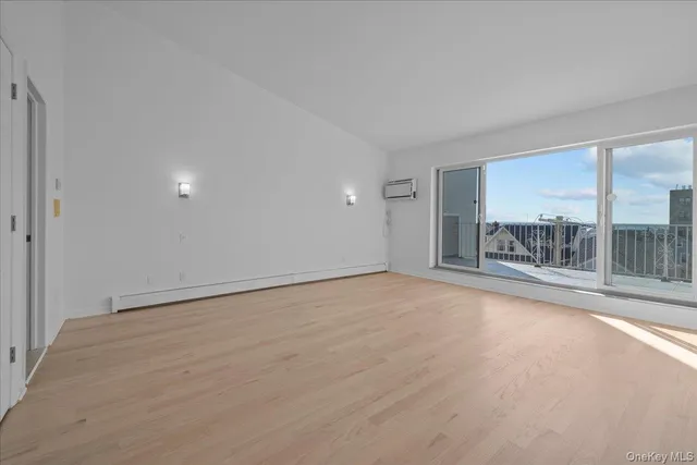 a view of an entryway with wooden floor and staircase