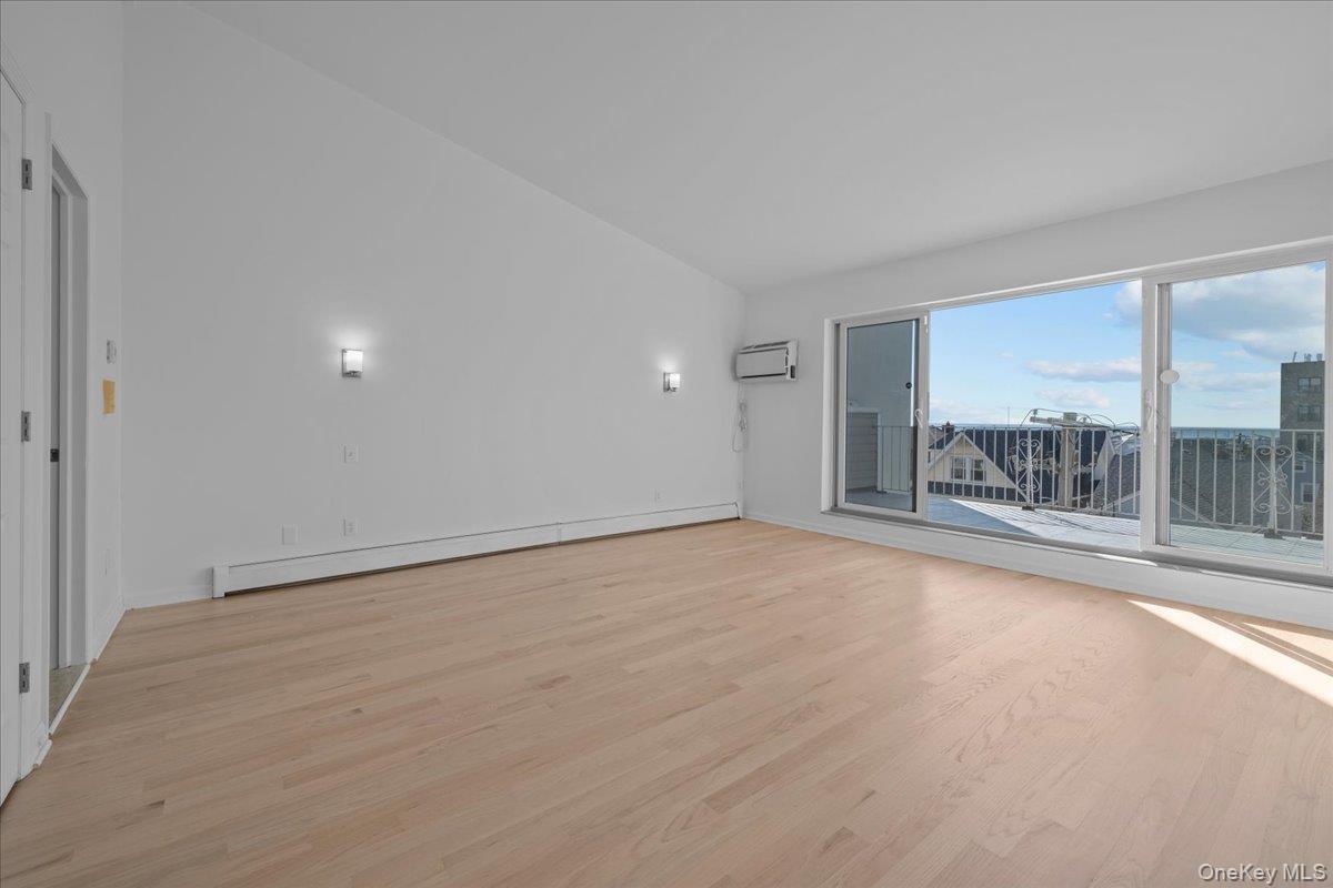 126 Beach 92nd Street, Unit 3C Queens, NY 11693 - Photo 9 of 16 a view of an empty room with a window