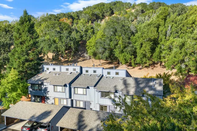 an aerial view of a house with a yard