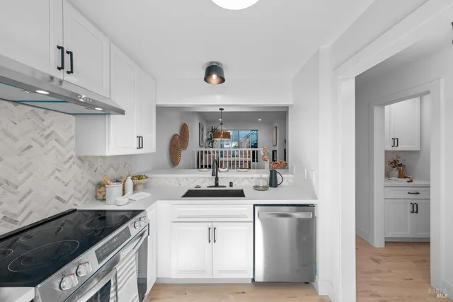 a kitchen with a sink stove and cabinets