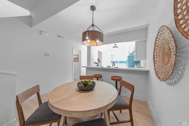 a dining room with furniture and a chandelier