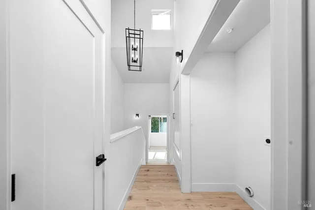 a view of a hallway with white walls and white walls