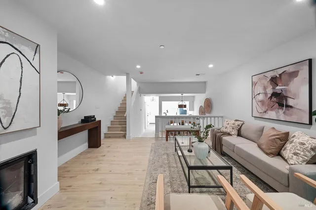 a living room with furniture a fireplace and a table