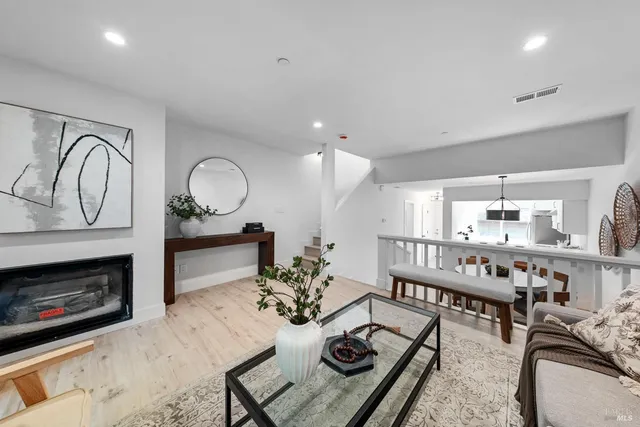 a view of a hallway with wooden floor and entryway