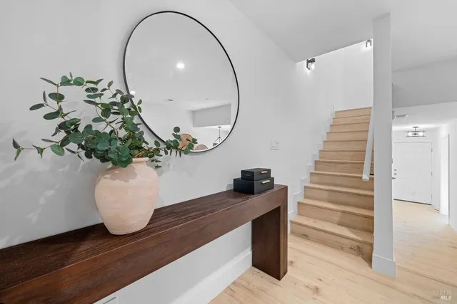 a view of entryway and hall with wooden floor