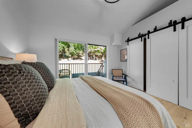 a bedroom with bed and a window