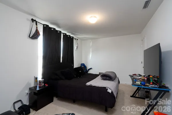 a bedroom with a bed and a flat tv screen