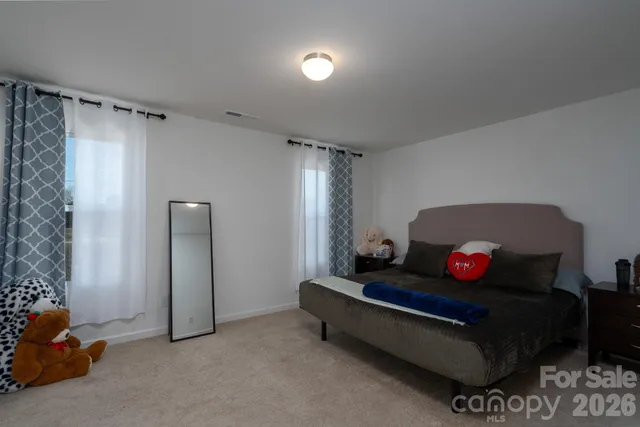 a living room with furniture and a gym machine