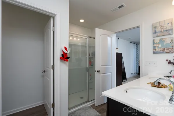 a bathroom with a sink mirror and shower