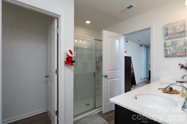 a bathroom with a sink mirror and shower