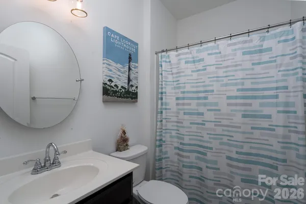 a bathroom with a sink a toilet and mirror