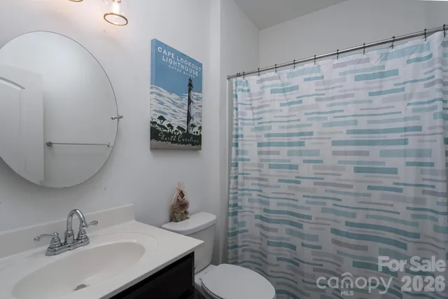 a bathroom with a sink a toilet and mirror