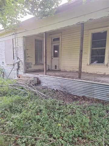 a view of house bedroom front and wooden fence