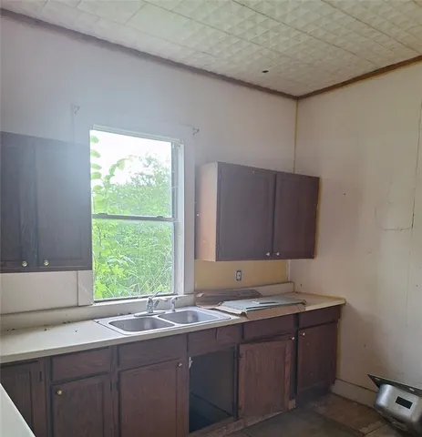 a kitchen with a sink and a window