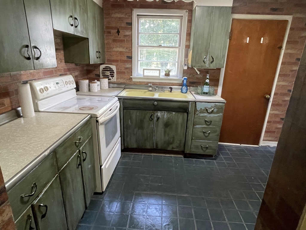 5 Brookfield Road Andover, MA 01810 - Photo 13 of 17 a kitchen with a sink stove and cabinets