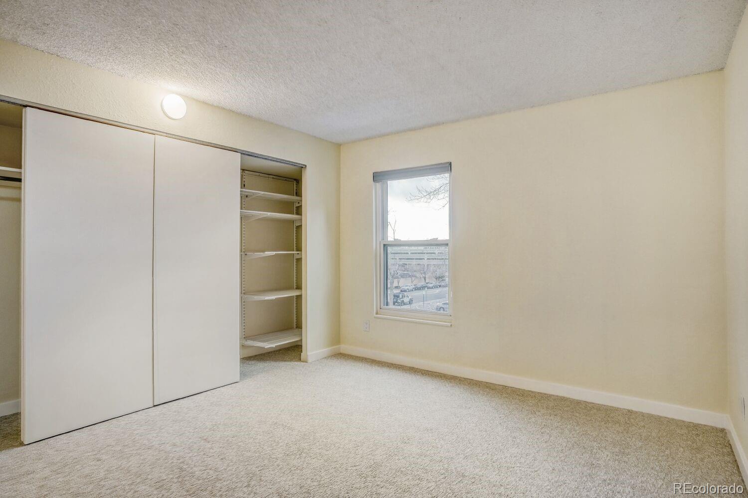 2 Adams Street, Unit 303 Denver, CO 80206 - Photo 11 of 14 an empty room with a empty space and windows
