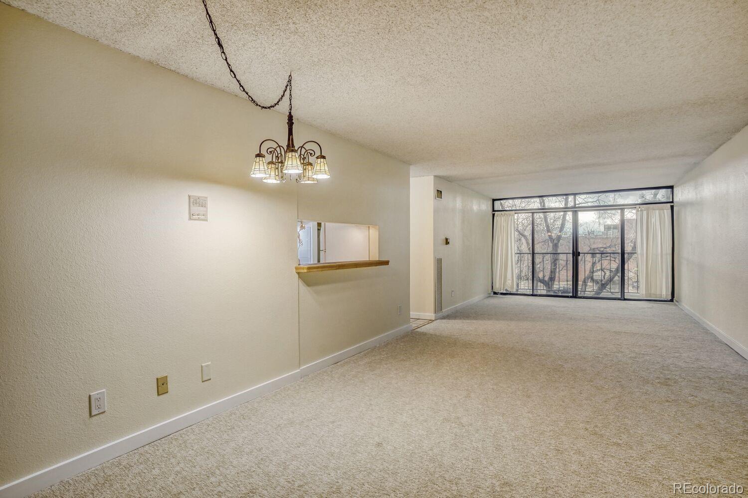 2 Adams Street, Unit 303 Denver, CO 80206 - Photo 5 of 14 a view of a room with windows and chandelier