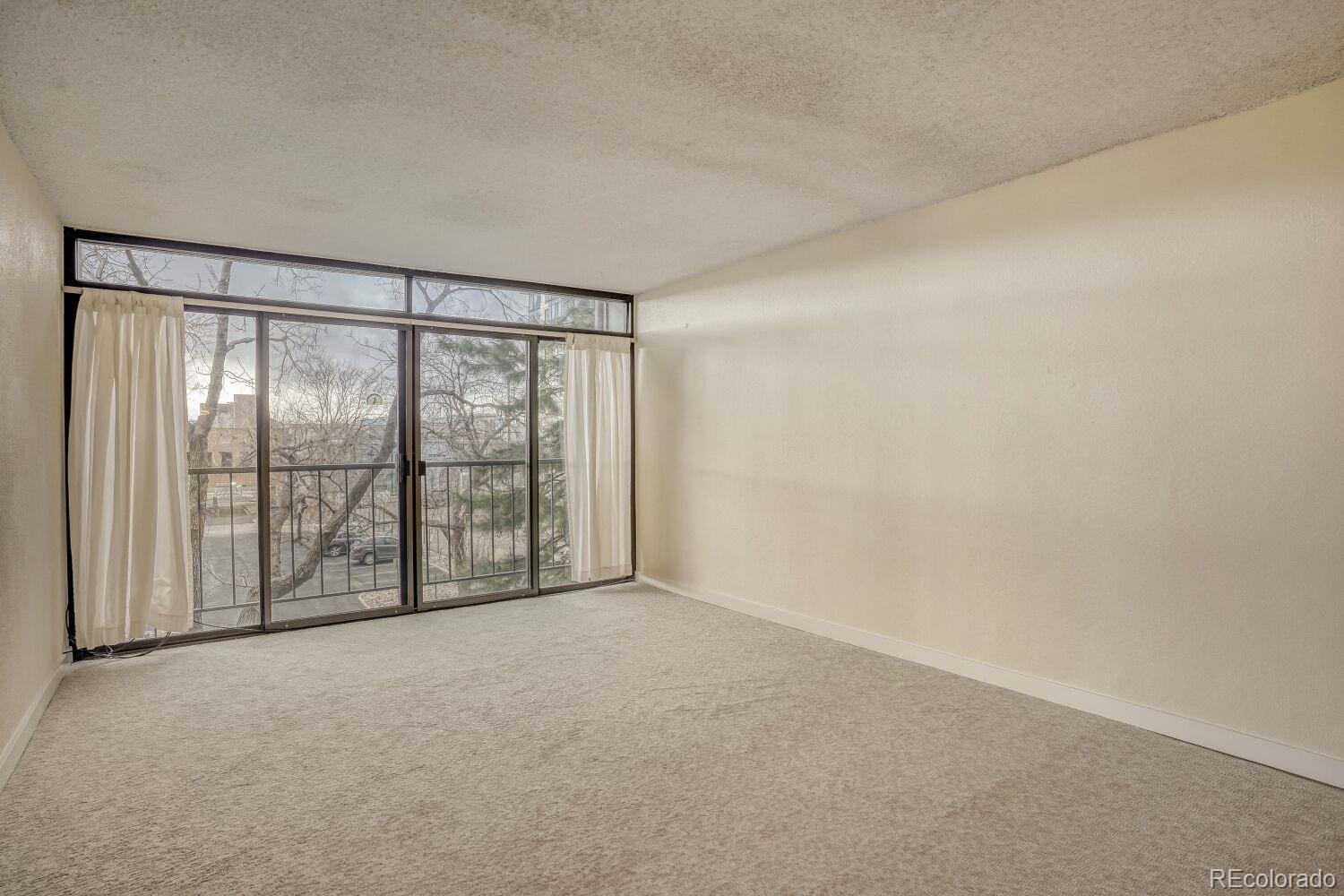 2 Adams Street, Unit 303 Denver, CO 80206 - Photo 6 of 14 a view of an empty room with a window